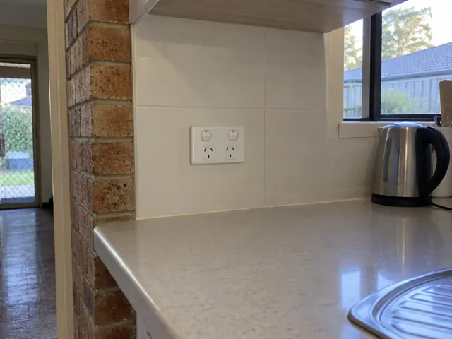 Double power point on a tiled kitchen splashback above a benchtop in The Ponds